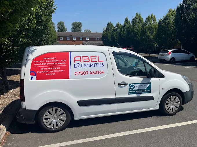The white Abel Locksmiths service van parked in the local area