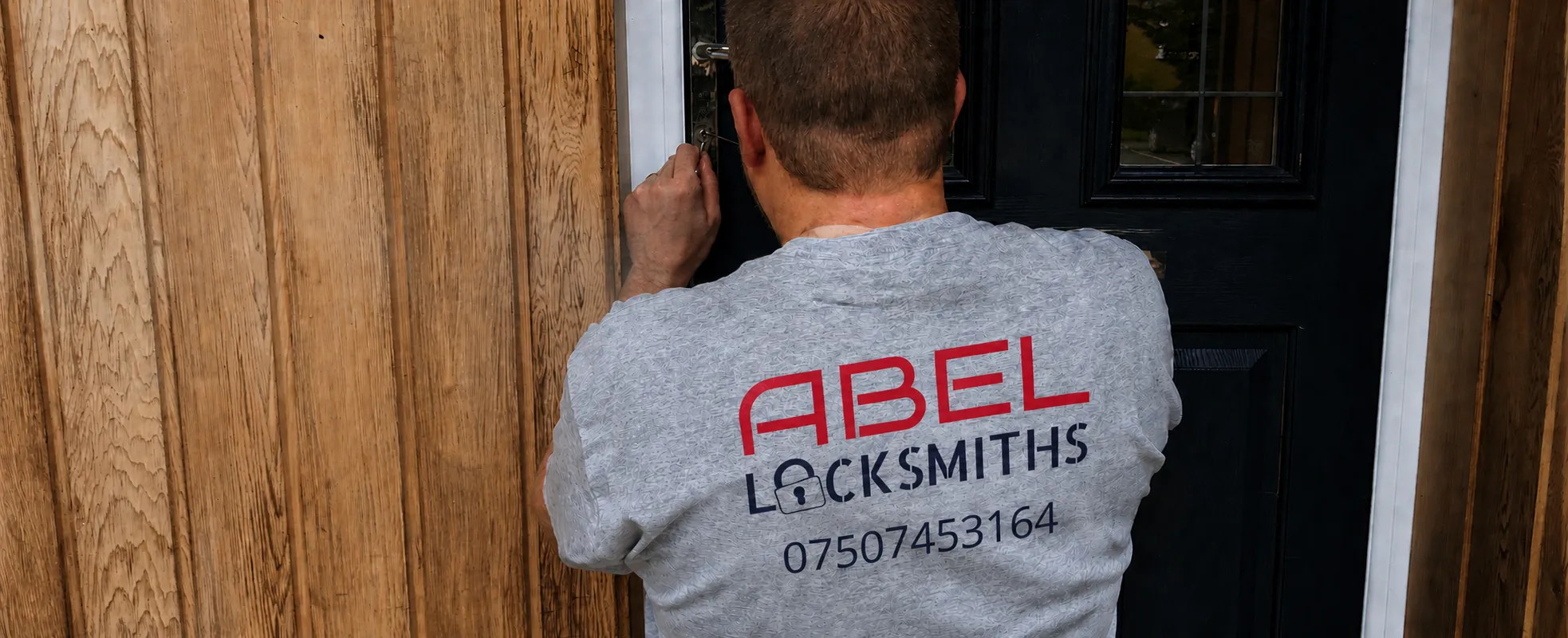 Andrew inspecting the handle of a timber front door during a repair visit